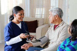 caregiver monitoring the patients blood pressure